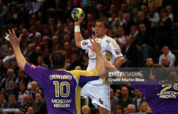 Momir Ilic of Kiel challenges Alexander Chernoivanov and Mikhail Chipurin of Medvedi for the ball during the EHF Champions League second leg round of...