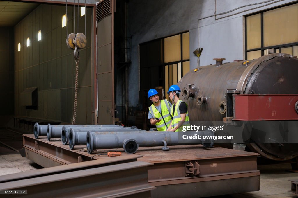 Moving Steel Workers Moving Large Steel Structure In A Machinery Factory High-Res ...