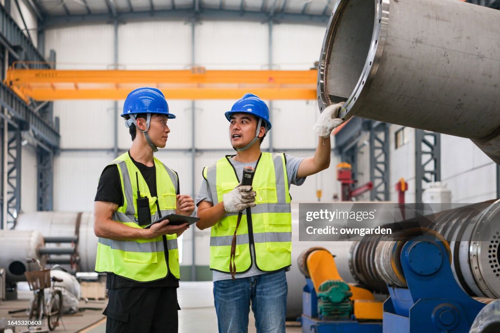 Moving Steel Workers Moving Large Steel Structure In A Machinery Factory High-Res ...