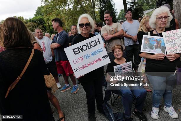 Staten Island residents gather to protest outside of a closed Catholic school-turned-migrant shelter on Staten Island on August 28, 2023 in New York...