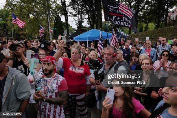 Staten Island residents gather to protest outside of a closed Catholic school-turned-migrant shelter on Staten Island on August 28, 2023 in New York...