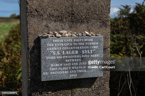 Plaque is displayed a gate post that marks the entrance to Lager Sylt Nazi concentration camp, one of four camps that were built on Alderney during...