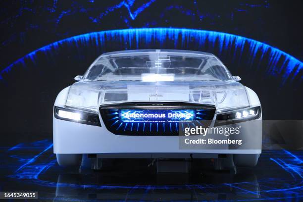 An automobile model displaying electric vehicle technologies shows a panel reading "Autonomous Driving" at the Samsung SDI Co. Pavilion on the...