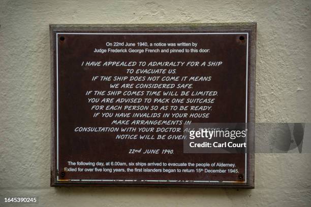 World War II evacuation notice is displayed on the old court house, on September 3, 2023 in Alderney, Guernsey. This year, the British government is...