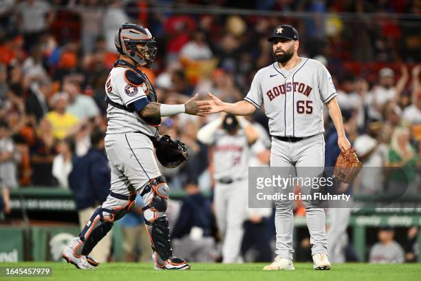 Jose Urquidy of the Houston Astros high-fives Martin Maldonado after a game against the Boston Red Sox at Fenway Park on August 28, 2023 in Boston,...