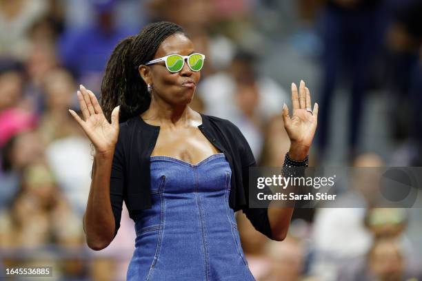 Former first lady of the United States Michelle Obama reacts during a ceremony honoring 50 years of equal pay at the U.S Open during the Women/Men's...