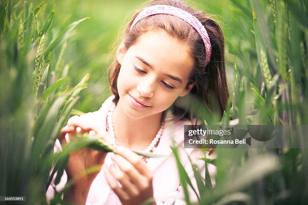 Portrait of girl in wheat field smiling
