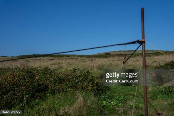 Rope marks off an area of Longis Common, believed to be the site of mass graves for prisoners executed or worked to death by the Nazis while being...