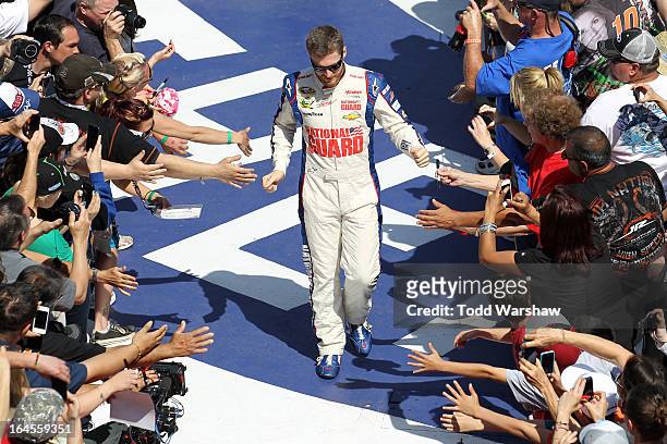Dale Earnhardt Jr., driver of the National Guard Chevrolet, greets fans before the start of the NASCAR Sprint Cup Series Auto Club 400 at Auto Club...