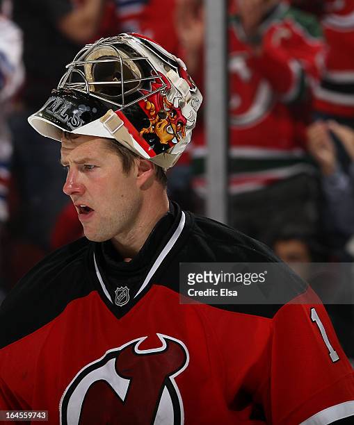 Johan Hedberg of the New Jersey Devils takes a break during a time out against the New York Rangers at the Prudential Center on March 19, 2013 in...