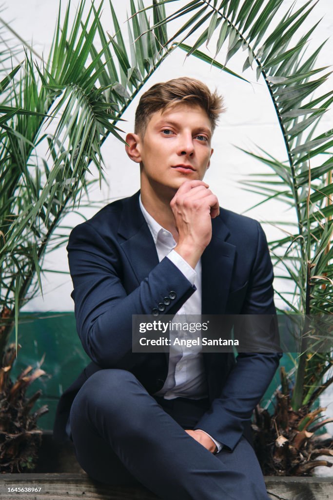 Male Professional Sunlit Portrait Near Greenery Outdoors