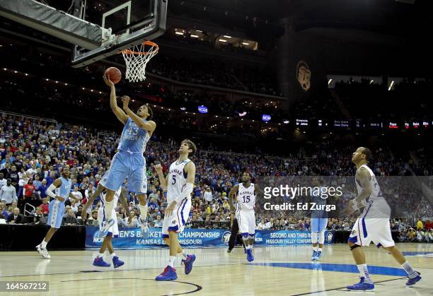 James Michael McAdoo of the North Carolina Tar Heels attempts a shot against Jeff Withey of the Kansas Jayhawks during the third round of the 2013...