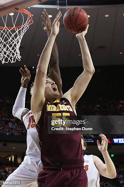 Elliott Eliason of the Minnesota Golden Gophers goes up against Will Yeguete of the Florida Gators in the first half during the third round of the...