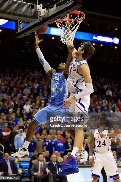 Dexter Strickland of the North Carolina Tar Heels drives for a shot attempt against Jeff Withey of the Kansas Jayhawks during the third round of the...