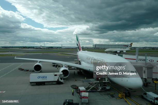 An Emirates A380 waits for passengers to board from the gate at Heathrow Airport on January 03, 2023 in London, England.