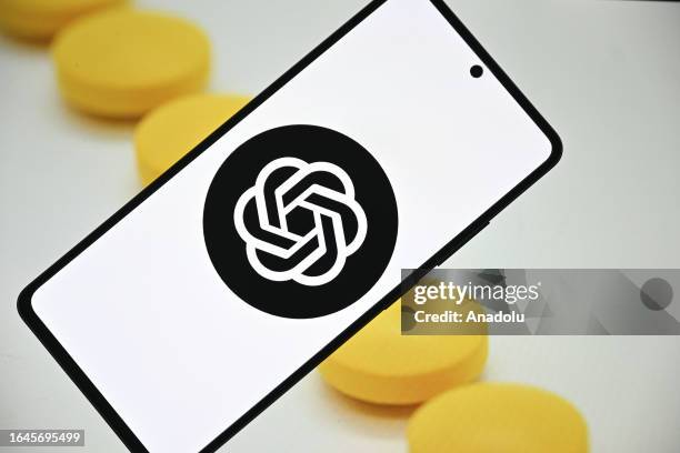 In this photo illustration, ChatGPT logo is being displayed on a mobile phone screen in front of a computer screen displaying pharmaceutical oral...