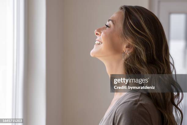 thinking, face and profile of woman by window, motivation and future goals. - pretty woman smiling face forward stock pictures, royalty-free photos & images
