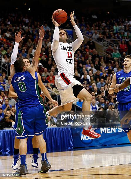 James Rahon of the San Diego State Aztecs shoots against Brett Comer of the Florida Gulf Coast Eagles in the second half during the third round of...