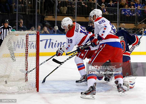 Nicklas Backstrom of the Washington Capitals scores a goal as teammate Troy Brouwer watches as goalie Henrik Lundqvist of the New York Rangers is...
