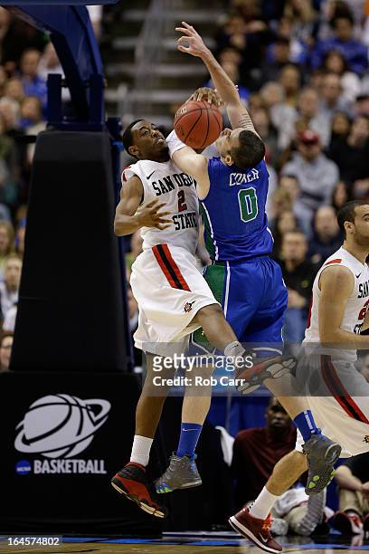 Xavier Thames of the San Diego State Aztecs and Brett Comer of the Florida Gulf Coast Eagles battle for the ball in the second half during the third...