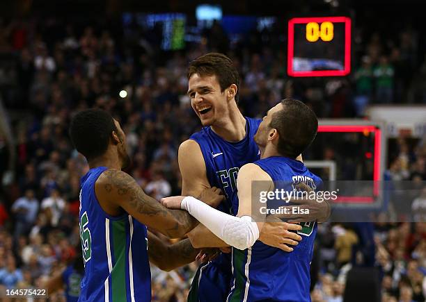 Dajuan Graf, Eddie Murray and Brett Comer of the Florida Gulf Coast Eagles celebrate after defeating the San Diego State Aztecs 81-71 during the...