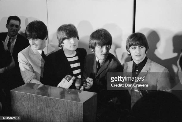 British pop group the Beatles hold a press conference at the airport upon their arrival to begin a US tour, Los Angeles, California, August 1964....