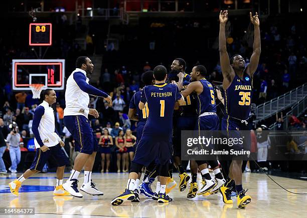 Rohan Brown of the La Salle Explorers celebrates with his teammates after they won 76-74 against the Mississippi Rebels during the third round of the...
