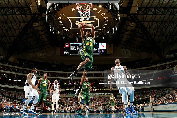 Jeremy Evans of the Utah Jazz dunks against Bernard James of the Dallas Mavericks on March 24, 2013 at the American Airlines Center in Dallas, Texas....