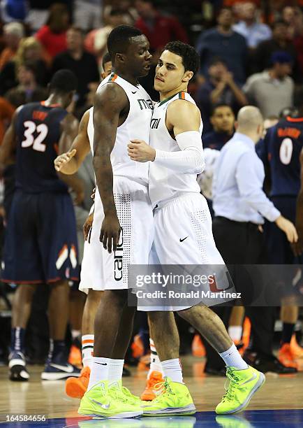 Shane Larkin and Durand Scott of the Miami Hurricanes celebrate in the second half against the Illinois Fighting Illini during the third round of the...