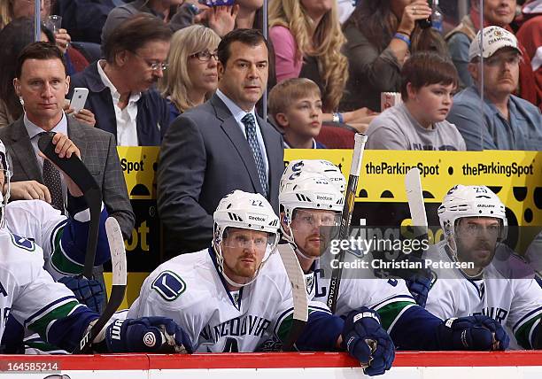 Head coach Alain Vigneault of the Vancouver Canucks watches from the bench during the NHL game against the Phoenix Coyotes at Jobing.com Arena on...