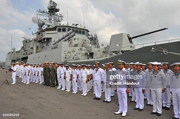 In this handout images provided by the Australian Department of Defence, Crews of HMAS Parramatta and HTMS Phutta Yotfa Chulalok stand at attention...