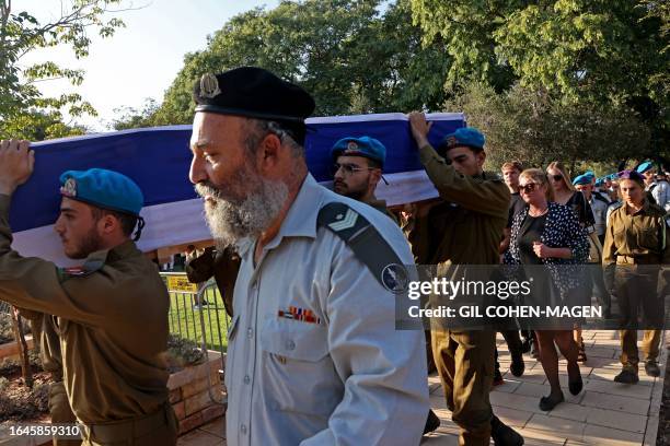 Israeli soldiers carry the coffin of fellow soldier Maksym Molchanov during his funeral in Tel Aviv on September 5, 2023. A Palestinian rammed a...