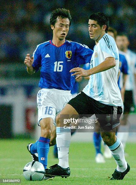 Juan Roman Riquelme of Argentine National Team and Toshiya Fujita of Japan in action.