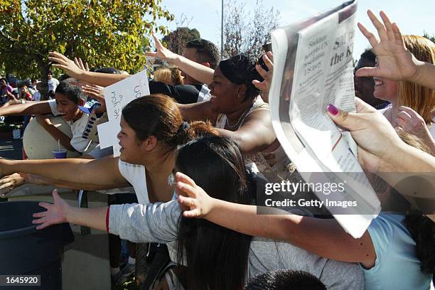 Fans reach out for musician Michael Jackson as he arrives at his civil trial in Santa Maria Superior Court on November 15, 2002 in Santa Maria,...