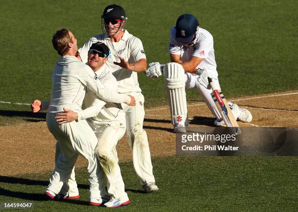 Kane Williamson, Brendon McCullum and Hamish Rutherford of New Zealand celebrate the wicket of Alastair Cook of England during day four of the Third...