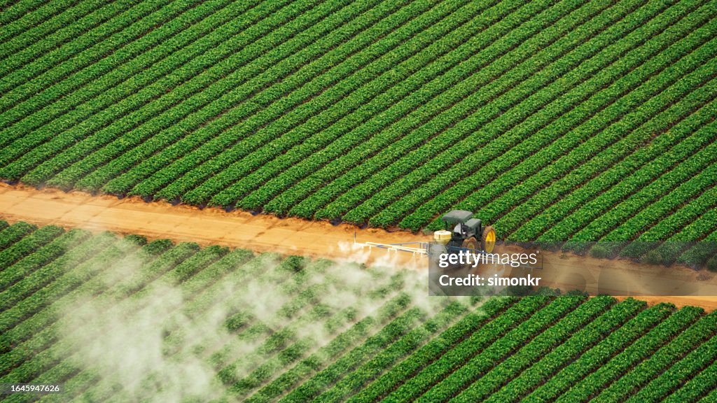 Tractor spraying fertilizer