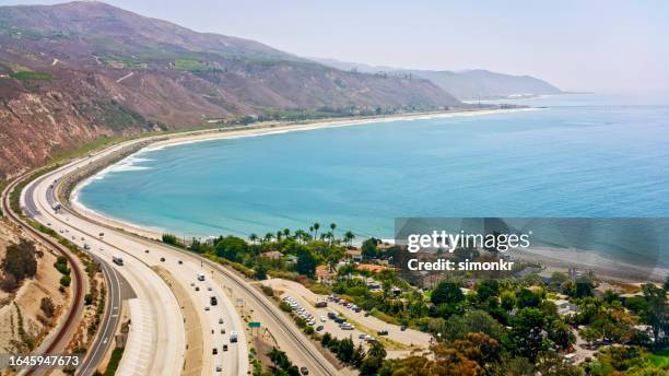 vehicles driving on coastal road - california coast car stock pictures, royalty-free photos & images
