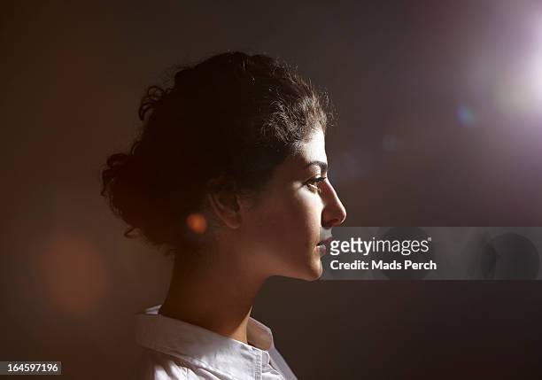 young woman with flare behind her