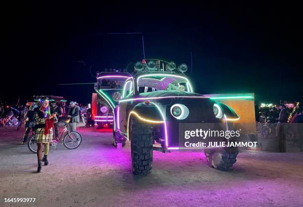 Attendees look at art cars during the annual Burning Man Festival on September 4, 2023. Thousands of revelers stuck in the mud for days at the...
