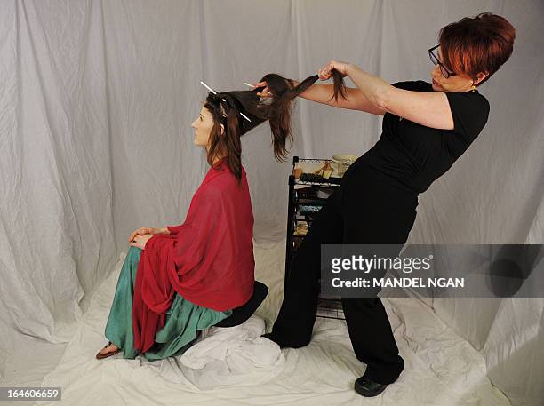 By FABIENNE FAUR - FILES - Hairdress Janet Stephens works on the hair of model Jackie Rose Womelsdorf to recreate the hairstyle worn by Roman Empress...