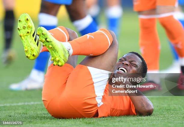 Blackpool's Karamoko Dembele winces in pain after injuring his wrist during the EFL Trophy Northern Group A match between Barrow and Blackpool at at...