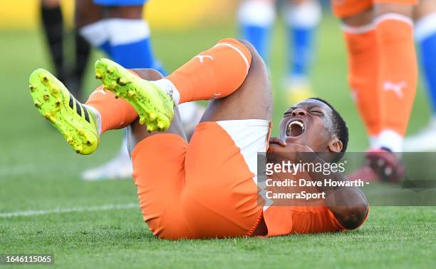 Blackpool's Karamoko Dembele winces in pain after injuring his wrist during the EFL Trophy Northern Group A match between Barrow and Blackpool at at...