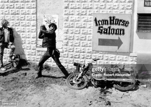 Harley-Davidson motorcycle rider takes a swing at a Japanese motorcycle at a Daytona Beach, Florida, bar's 'Wap-A-Jap' event during the annual Bike...