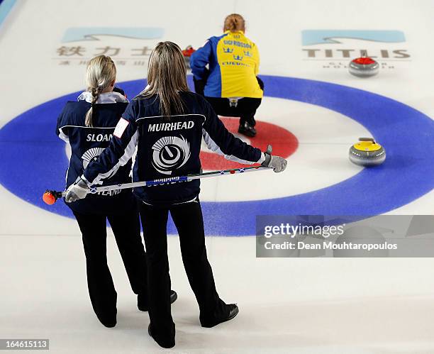 Anna Sloan and Eve Muirhead of Scotland and Margaretha Sigfridsson of Sweden look on in the Gold medal match between Sweden and Scotland on Day 9 of...