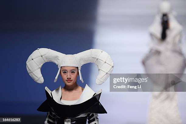 Model showcases designs on the catwalk during Hempel Award the 21st China International Young Fashion Designers Contest on the second day of...