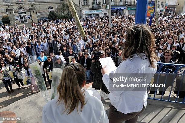 Students read an homage on March 25, 2013 during a ceremony and march in honour of Sylvain, a 15-year-old schoolboy stabbed on March 19 by a...