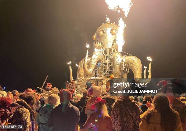 Attendees dance during the annual Burning Man Festival in the early morning of September 5, 2023. Thousands of revelers stuck in the mud for days at...