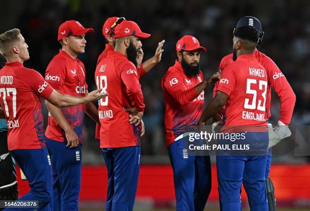 England's Rehan Ahmed celebrates with teammates after taking the wicket of New Zealand's Tim Seifert for 48 runs during the fourth T20 international...