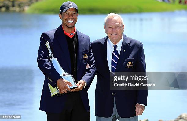 Tiger Woods of the United States is presented with the trophy by Arnold Palmer of the United States, the win meant he re-gained the World's number...