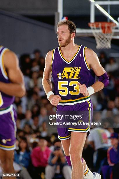 Mark Eaton of the Utah Jazz runs against the Phoenix Suns during a game played on November 2, 1990 at the Tokyo Metropolitan Gymnasium in Tokyo,...